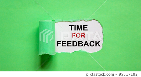 The text 'time for feedback' appearing behind torn green paper. The text 'time for feedback' appearing behind torn green paper. 95317192