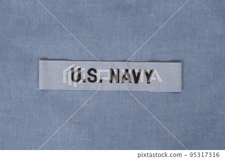 US NAVY branch tape on navy blue uniform US NAVY branch tape on navy blue uniform 95317316