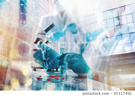 Doctor in the laboratory analyzes samples of codiv-9 under a microscope 95317492