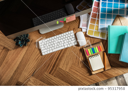 Designer's workplace with modern computer and color palettes, flat lay. Space for text Designer's workplace with modern computer and color palettes, flat lay. Space for text 95317958
