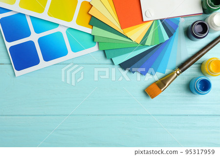 Flat lay composition with color palettes on light blue wooden background. Space for text Flat lay composition with color palettes on light blue wooden background. Space for text 95317959