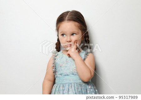 Cute little girl on light grey background Cute little girl on light grey background 95317989