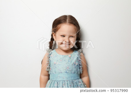 Cute little girl on light grey background Cute little girl on light grey background 95317990