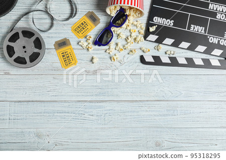 Flat lay composition with clapperboard, cinema tickets and 3d glasses on white wooden table 95318295
