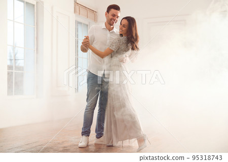 Lovely young couple dancing together in ballroom 95318743