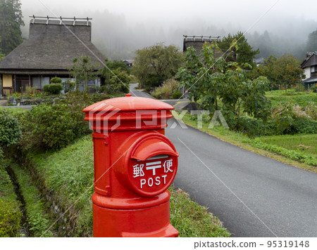 Red round mailbox in Miyama Kayabuki no Sato 95319148