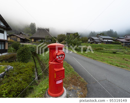 Red round mailbox in Miyama Kayabuki no Sato 95319149