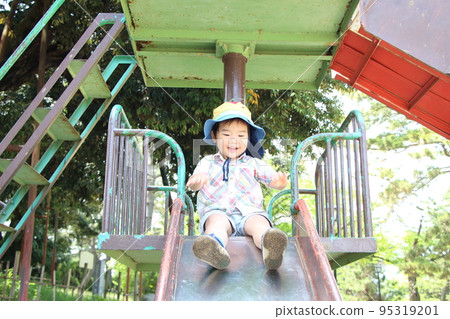 Boys playing on a slide 95319201