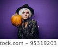 Scared surprised witch with grey hair on Halloween 95319203