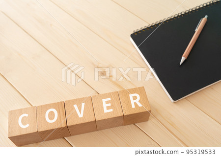 A block written as COVER, a pen and a notebook A block written as COVER, a pen and a notebook 95319533