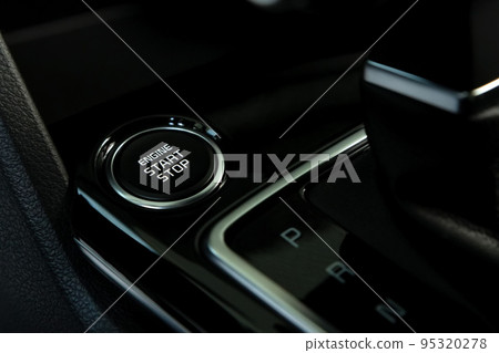 Engine start button in modern car close Engine start button in modern car close 95320278