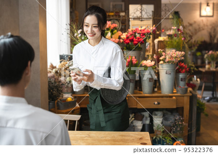 A young woman working in a cafe A young woman working in a cafe 95322376
