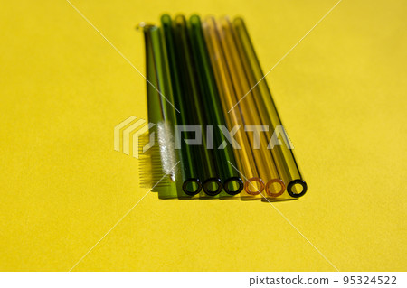 Reusable glass Straws on colorful background Eco-Friendly Drinking Straw Set with cleaning brush Reusable Comfortable Rounded tip Drinking Straw 95324522