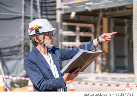 Construction supervisor who compares design drawings with the construction site White hair and beard Construction supervisor who compares design drawings with the construction site White hair and beard 95324781