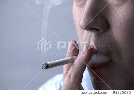 Mouth of a man smoking a cigarette 95325020
