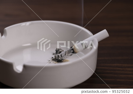 Forgot to extinguish the cigarette left in the ashtray 95325032