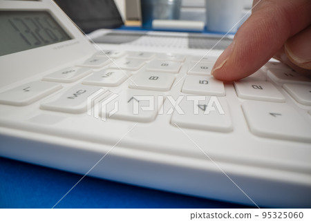 Close-up view of using calculator, shot with macro probe lens Close-up view of using calculator, shot with macro probe lens 95325060