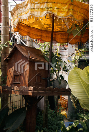 A wooden spirit house or tope taveda in khmer, believed to be a shrine to the protective spirit of a place A wooden spirit house or tope taveda in khmer, believed to be a shrine to the protective spirit of a place 95327286