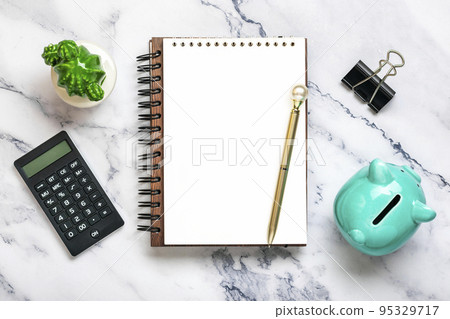 Notepad, piggy bank, home plant, calculator, pen on marble background Financial planning, goals, project for New Year concept Top view Flat lay Finance training and strategies Copy space. Notepad, piggy bank, home plant, calculator, pen on marble background Financial planning, goals, project for New Year concept Top view Flat lay Finance training and strategies Copy space. 95329717