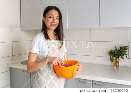 Portrait of confectioner woman In apron preparing to cook. 95330060