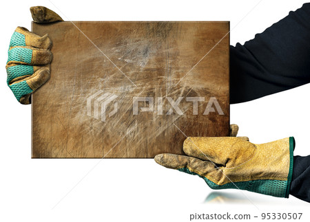 Manual Worker with Protective Work Gloves Holding a Rusty Metal Plate 95330507