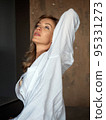 Beautiful adult woman stretches herself 95331273
