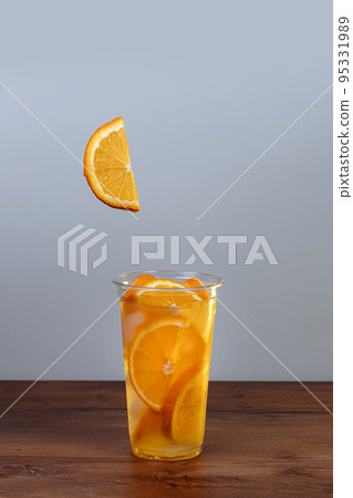 Drink with ice and orange slices Drink with ice and orange slices 95331989