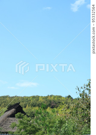 Japanese thatched roof and autumn sky 95332564