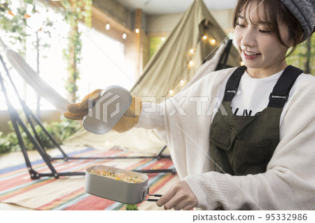 A young woman cooking at Mestin Shrimp pilaf 95332986