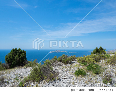 Calanques, France - May 20th 2020: Hiking high above the Mediterranean Sea along a rocky coast 95334234