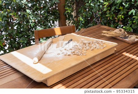 Preparing south italian traditional pasta orecchiette outdoor in the house yard 95334315