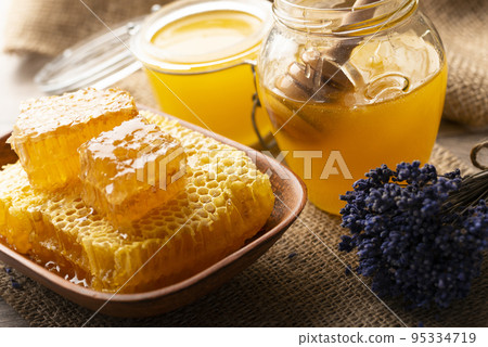 Honeycomb in clay dish on kitchen table sweet background Honeycomb in clay dish on kitchen table sweet background 95334719