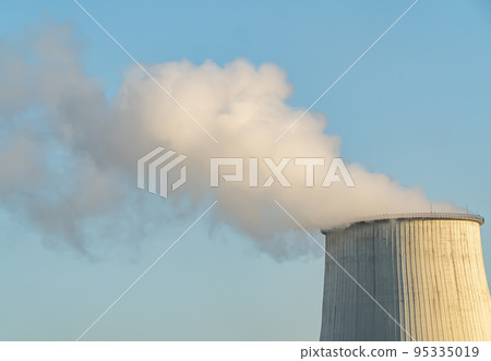 Smokestack of a thermal power plant against a blue sky. 95335019