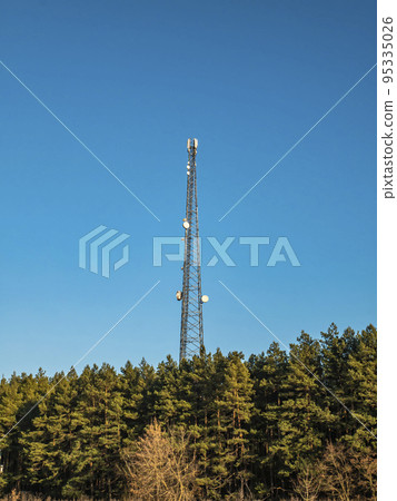 Mobile communications tower on a background of blue sky. Mobile communications tower on a background of blue sky. 95335026