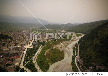 Panoramic aerial view to Berat old town and Osum river from Berat Castle , Albania Panoramic aerial view to Berat old town and Osum river from Berat Castle , Albania 95335323