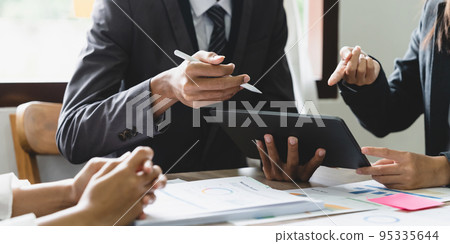 Business people are meeting for analysis data figures to plan business strategies. Business discussing concept 95335644