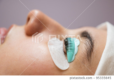 Profile of a woman in a beauty salon on the procedure of eyelash lamination.  95335645