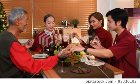 Happy family holding hands and praying before Christmas meal. Christmas, New year, thanksgiving and celebration concept 95336192