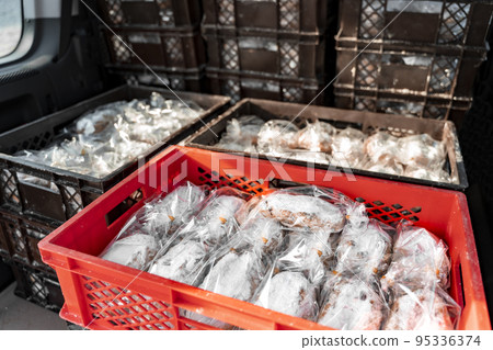 Delivery truck with Stollen Christmas pie packed in trunk near bakery shop. 95336374