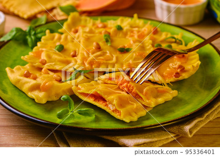 Homemade Pumpkin Ravioli with ricotta cheese served basil Homemade Pumpkin Ravioli with ricotta cheese served basil 95336401