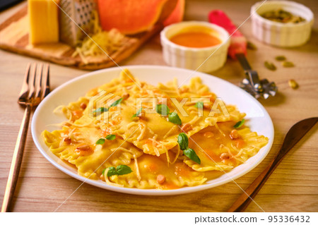 Homemade Pumpkin Ravioli with ricotta cheese served basil Homemade Pumpkin Ravioli with ricotta cheese served basil 95336432