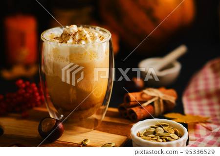 Pumpkin latte with whipped cream in a glasses Pumpkin latte with whipped cream in a glasses 95336529