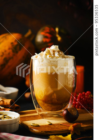 Pumpkin latte with whipped cream in a glasses 95336535
