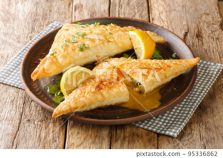 Tunisian Deep fried brik pastry with tuna and egg filling close up in the plate. Horizontal 95336862