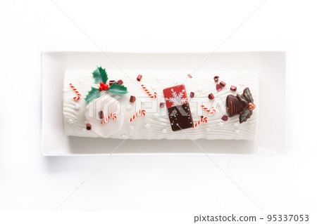 White chocolate yule log cake with christmas ornament isolated on white background 95337053