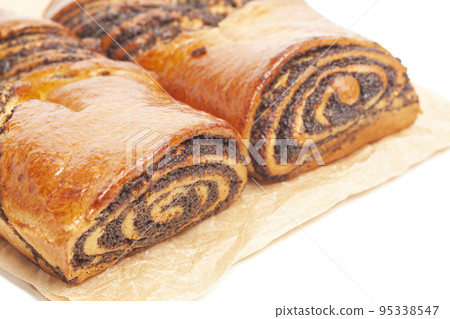poppy seed strudel on a brown baking paper isolated on white 95338547
