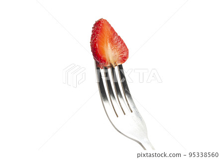 Strawberry on a fork isolated on white. Strawberry on a fork isolated on white. 95338560