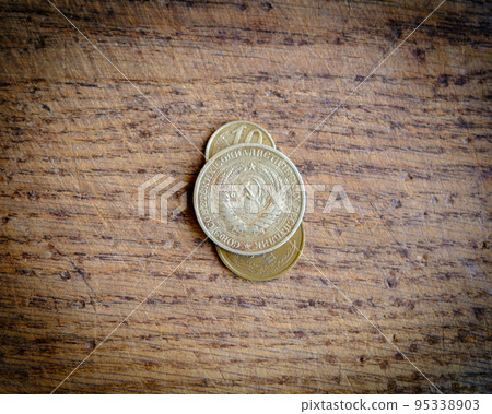 Soviet-era Russian ruble, coins. On the obverse, a coat of arms of the Soviet Union and a wooden background. Soviet-era Russian ruble, coins. On the obverse, a coat of arms of the Soviet Union and a wooden background. 95338903