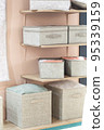 Organizing home storage. Organization of home space. Storage of things in the dressing room on the shelves in textile baskets and boxes 95339159