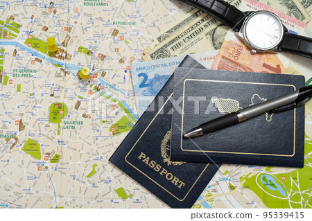 Different passports and different money on a map planning a vacation. Vacation concept, travel. Copy space Different passports and different money on a map planning a vacation. Vacation concept, travel. Copy space 95339415